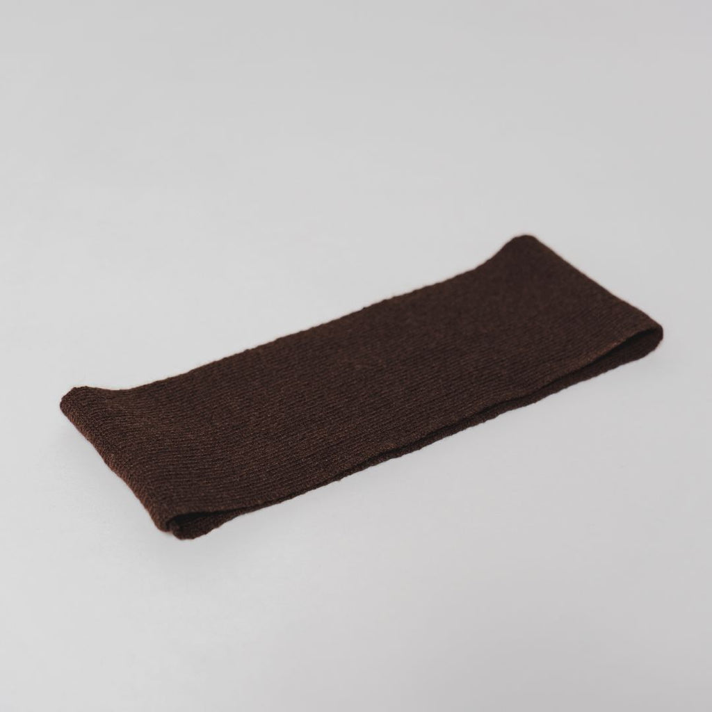 Flat lay of the brown Headband by Costa Knit Atelier, handcrafted from a premium cashmere and extra-fine merino wool blend for ultimate comfort