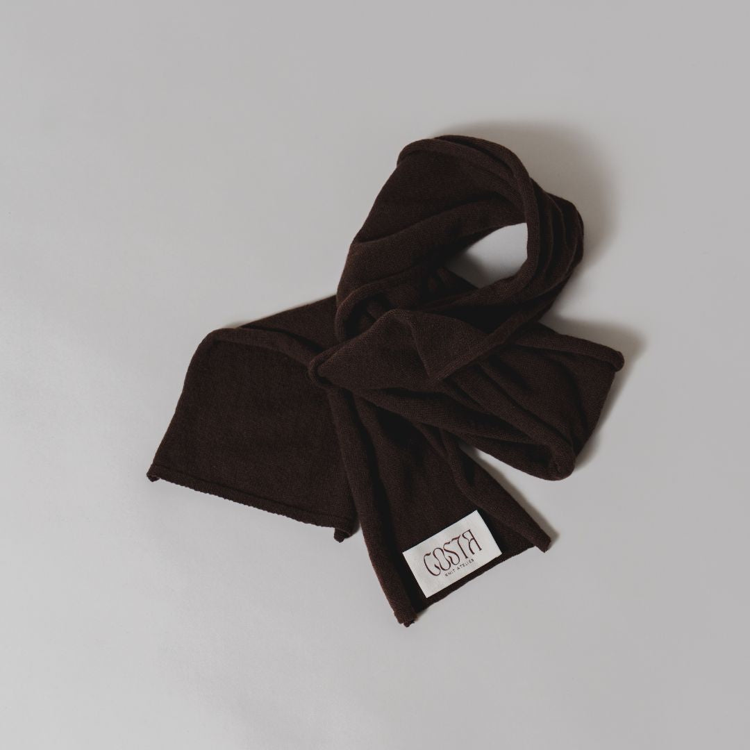 Flat lay of the brown Thin Scarf by Costa Knit Atelier, a premium cashmere and merino wool blend with a 90s minimalist silhouette.