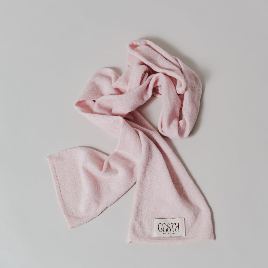 Flat lay of the pink Thin Scarf by Costa Knit Atelier, a premium cashmere and merino wool blend with a 90s minimalist silhouette.