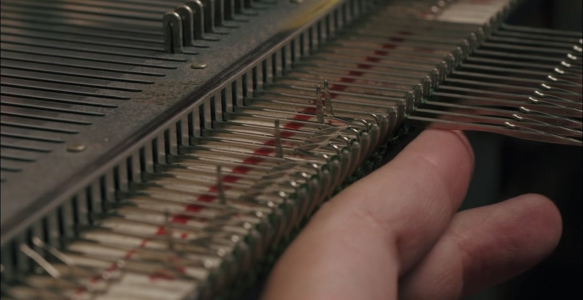 Close-up video of the traditional knitting machine process at Costa Knit Atelier, showcasing the artisanal precision and technical skill behind our luxury knitwear.